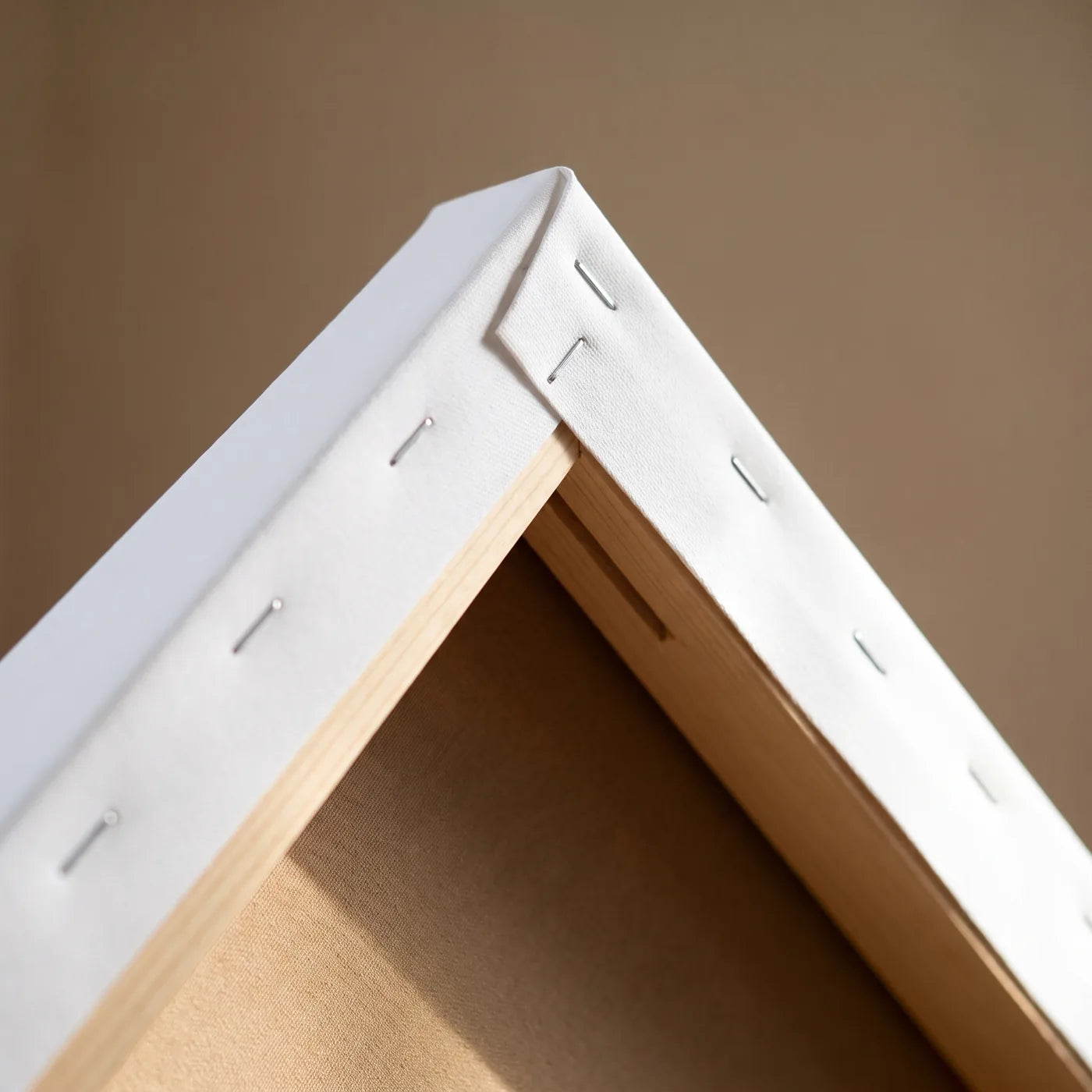 Corner of the 3D Stretcher Frame — Deep Spruce Stretcher Bar, Straight Row of Staples and Taut Canvas