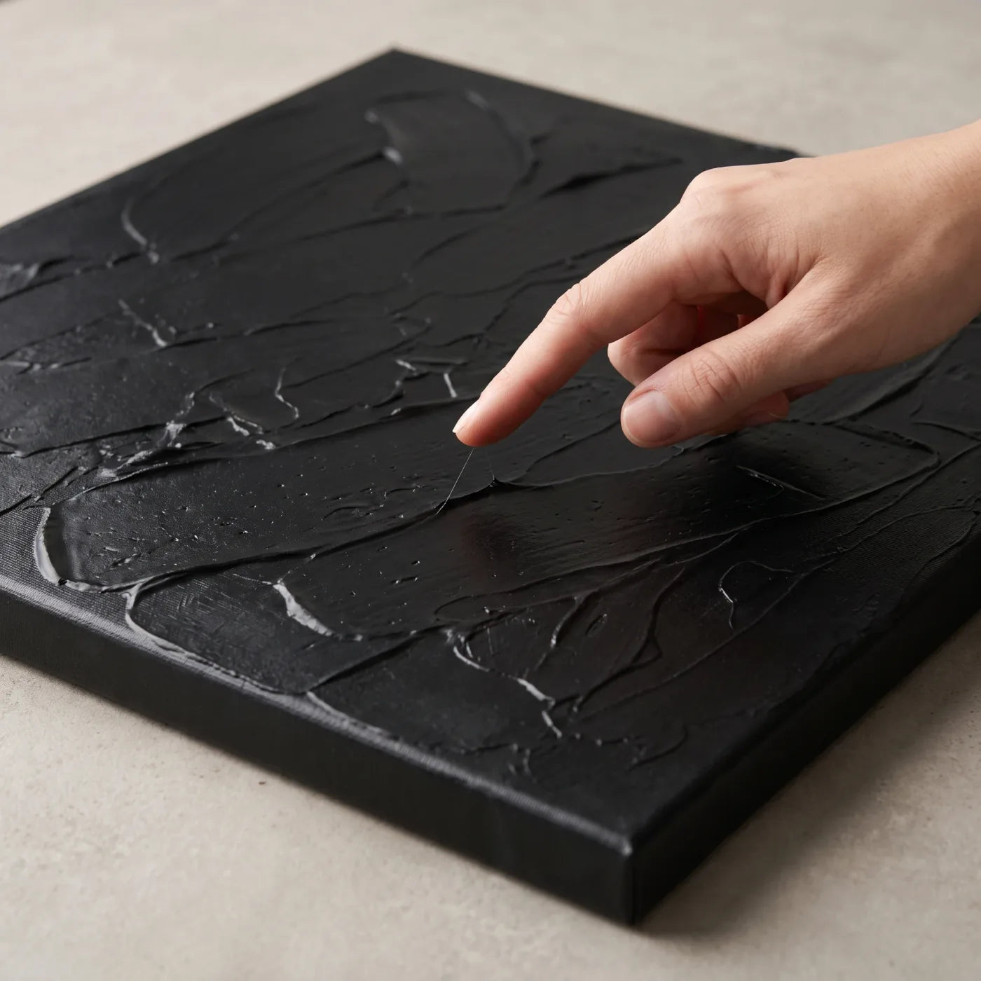 Checking the tackiness of mixtion with a finger on a black relief