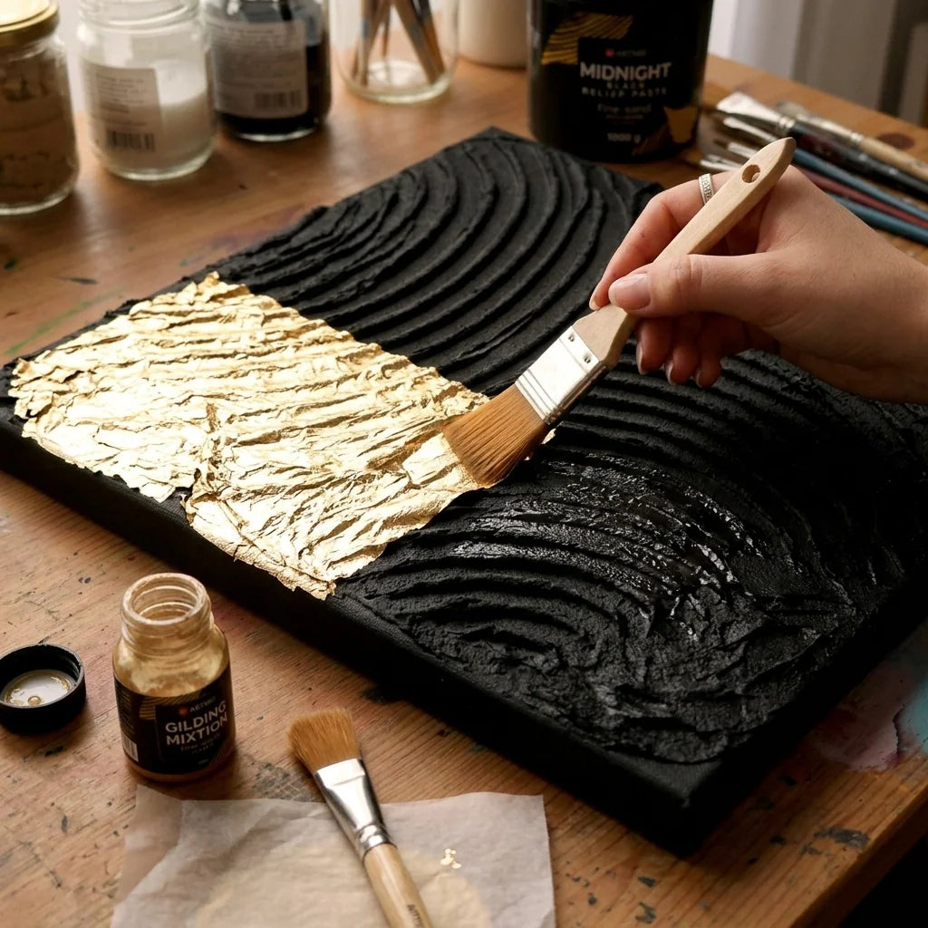 Applying gold leaf to a dry relief made with black Midnight paste